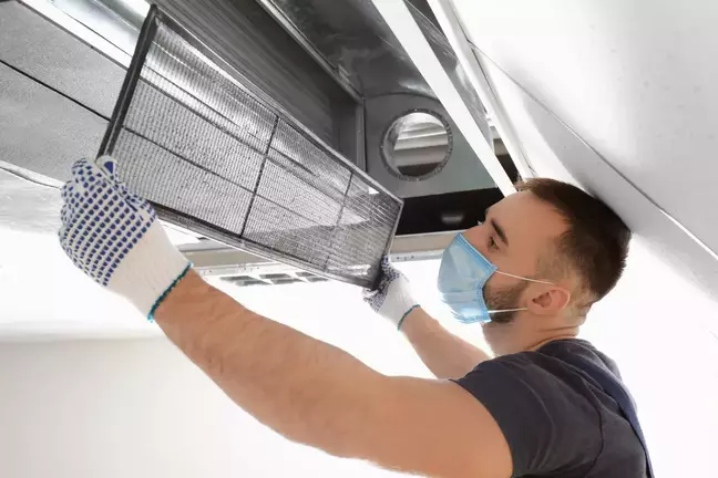 a man cleaning air filter